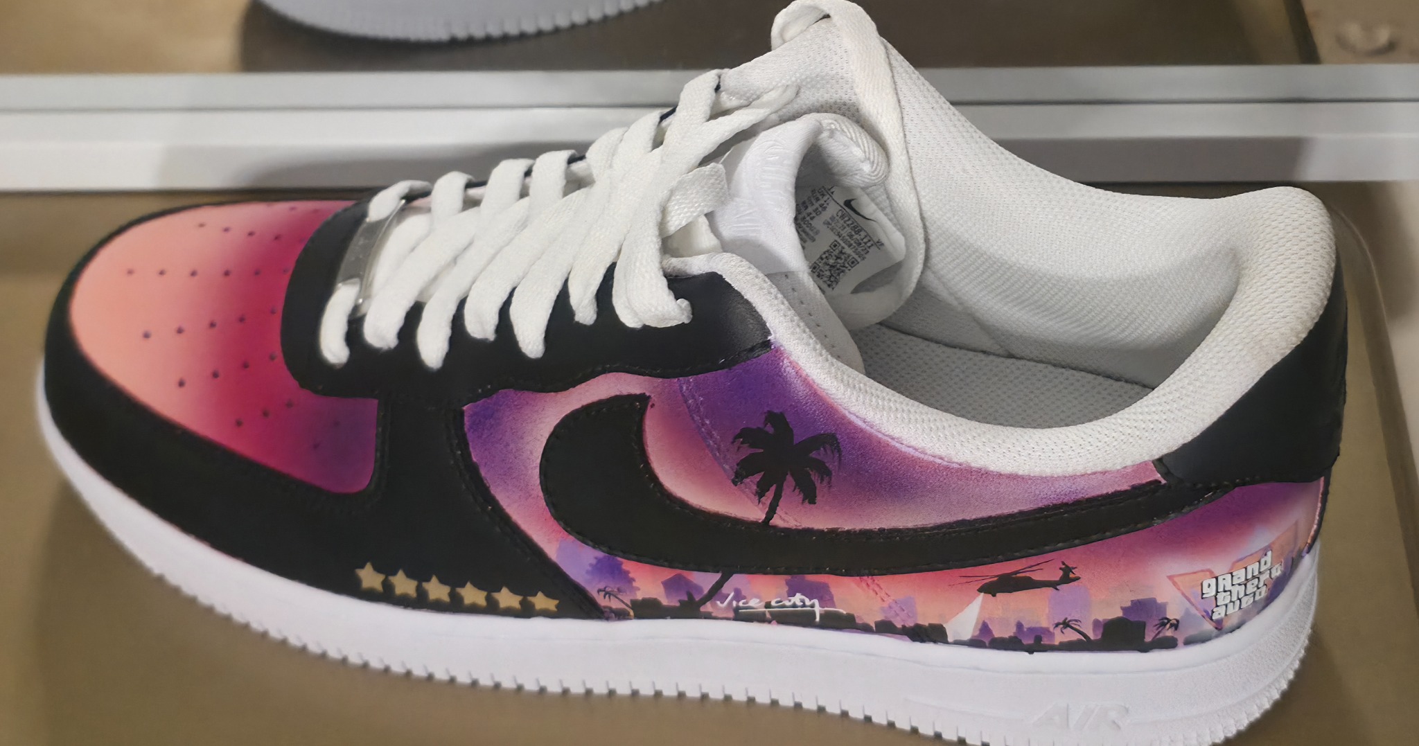 GTA trainer side profile with sunset and skyline artwork